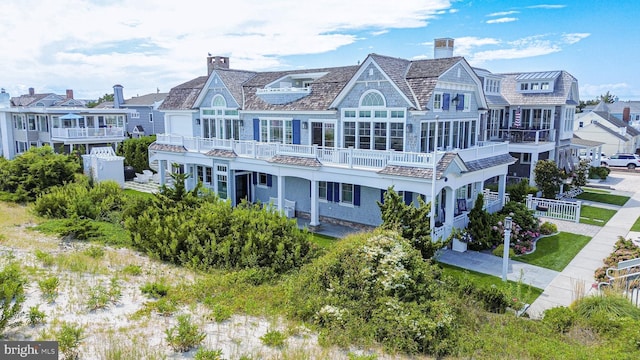 1 103rd St, Stone Harbor, NJ 08247 - back of house featuring a chimney and fence
