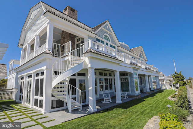 1 103rd St, Stone Harbor, NJ 08247 - rear view of property with a patio, fence, stairway, a yard, and a chimney