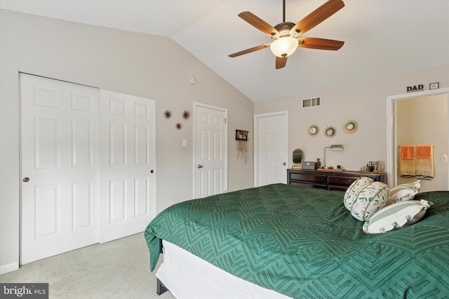 carpeted bedroom featuring visible vents, lofted ceiling, and ceiling fan