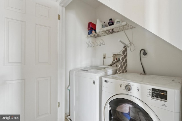 washroom featuring separate washer and dryer and laundry area