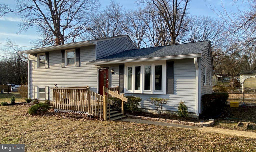 tri-level home with roof with shingles