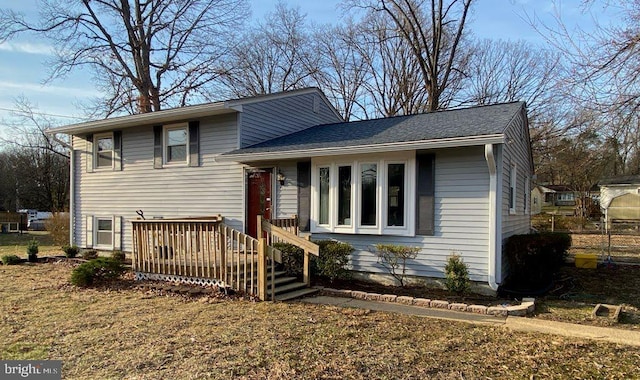 tri-level home with roof with shingles