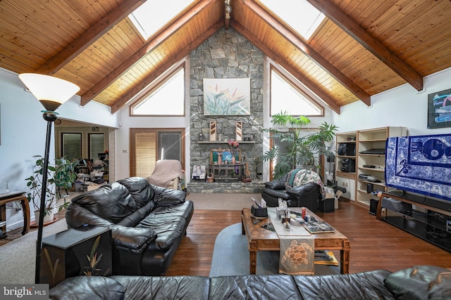 living room with a skylight, beam ceiling, high vaulted ceiling, and wood finished floors