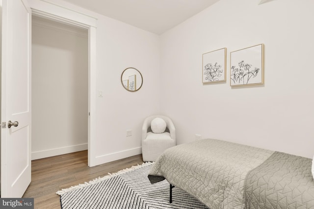 bedroom featuring wood finished floors and baseboards