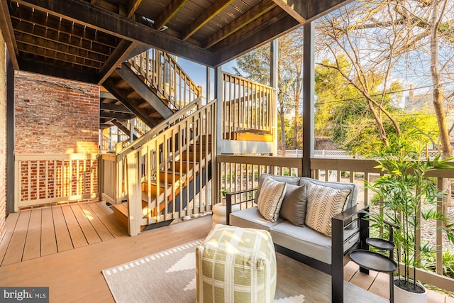 wooden terrace featuring stairs and an outdoor hangout area