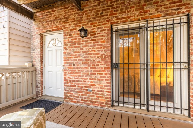 property entrance featuring brick siding