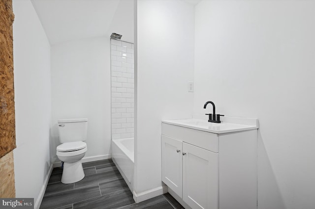 full bath featuring toilet, vanity, and baseboards