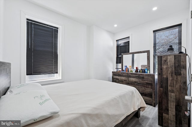 bedroom featuring wood finished floors and recessed lighting