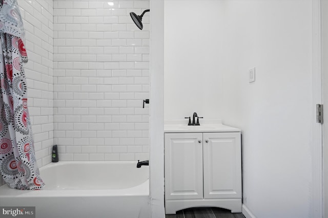 bathroom with shower / bath combo with shower curtain and a sink