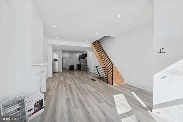 interior space with stairway, recessed lighting, and light wood-type flooring