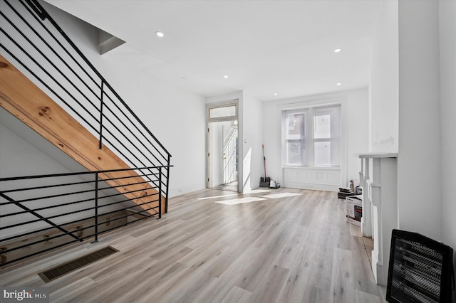 foyer with light wood-type flooring, visible vents, heating unit, recessed lighting, and stairs