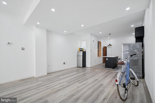 living area with light wood finished floors, recessed lighting, and baseboards