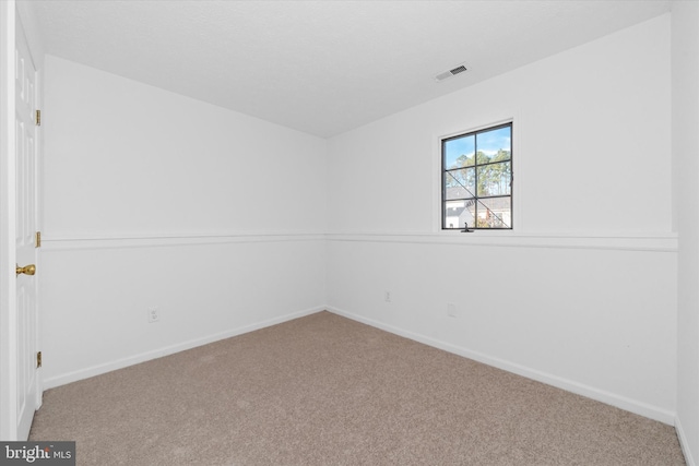 carpeted empty room with baseboards and visible vents