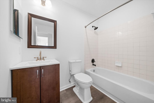 full bathroom featuring toilet, wood finished floors, shower / bath combination, baseboards, and vanity