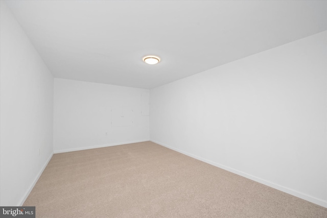 empty room with light carpet and baseboards