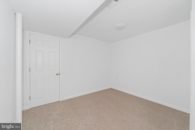 empty room with visible vents, baseboards, and carpet floors