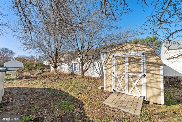 view of shed featuring fence