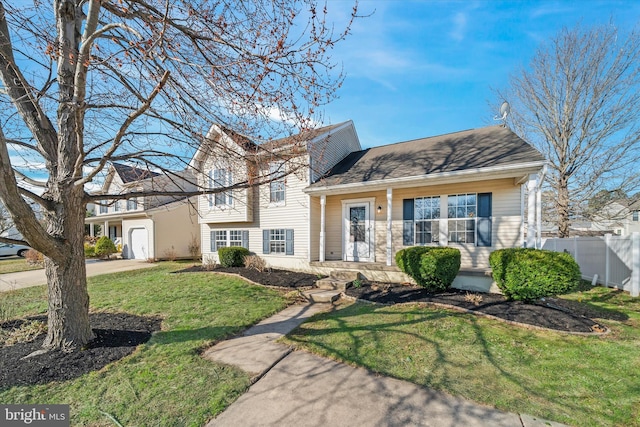 tri-level home featuring a front yard, fence, driveway, roof with shingles, and an attached garage