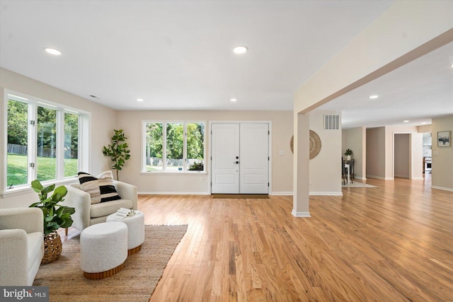 interior space featuring light wood-type flooring, visible vents, baseboards, and recessed lighting