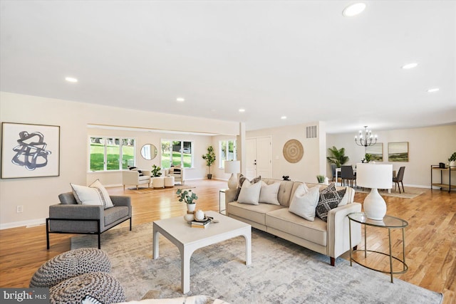 living area featuring recessed lighting, a notable chandelier, light wood-style floors, and visible vents