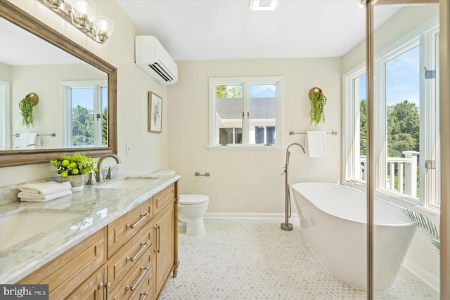 full bath featuring baseboards, a wall mounted AC, double vanity, a freestanding tub, and a sink