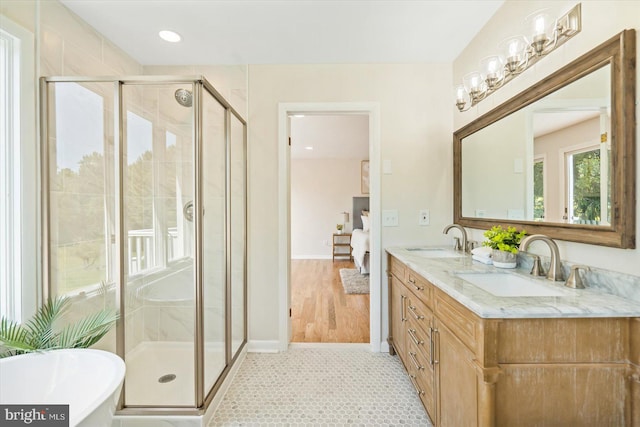 ensuite bathroom featuring a sink, a shower stall, and ensuite bathroom