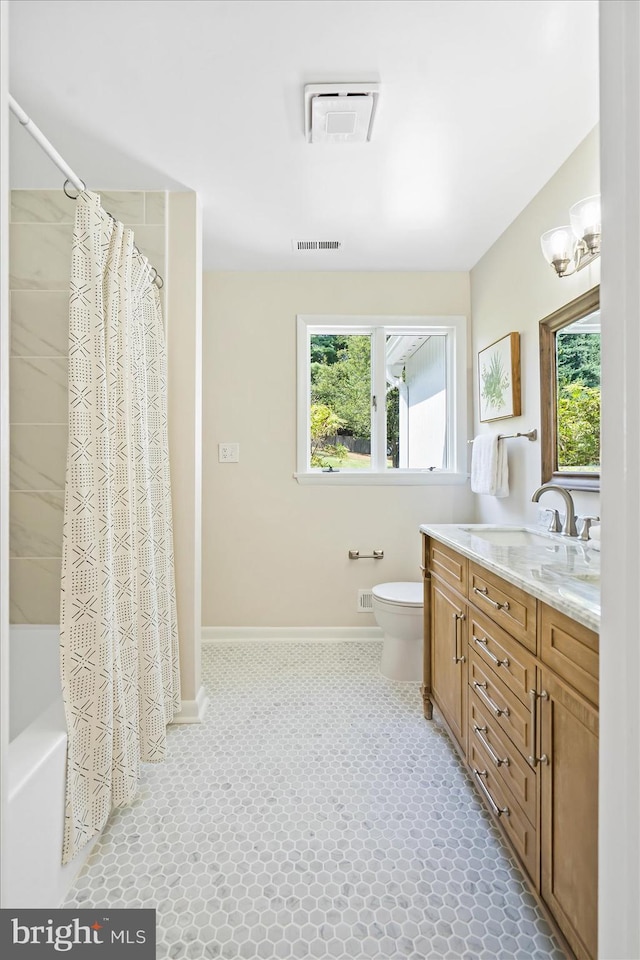 full bath featuring toilet, visible vents, and a wealth of natural light