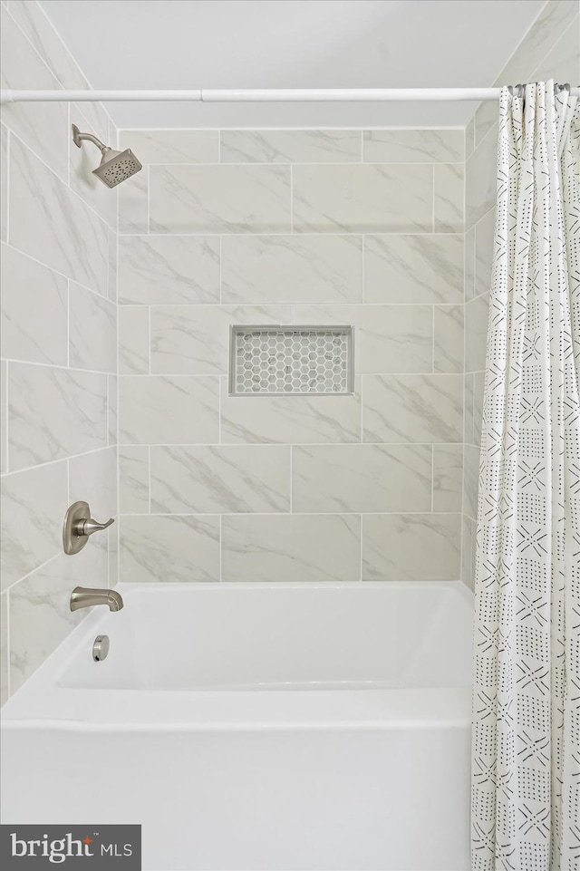 full bathroom with shower / bath combo with shower curtain