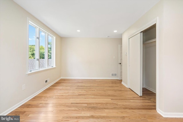 unfurnished bedroom featuring visible vents, baseboards, and light wood-style flooring