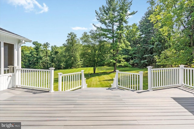 wooden terrace featuring a lawn