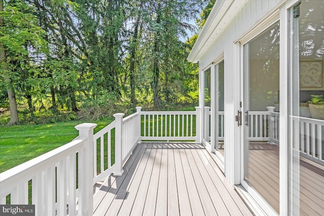 wooden deck featuring a yard