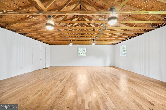 basement featuring wood finished floors and a healthy amount of sunlight