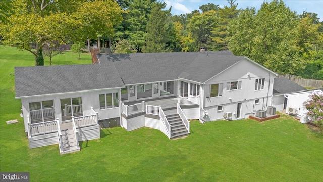 back of property featuring a shingled roof, stairway, central AC, a yard, and a deck