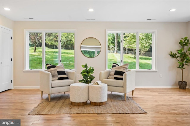 sitting room with recessed lighting, light wood-style floors, and baseboards