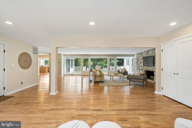 unfurnished living room featuring a fireplace, recessed lighting, and light wood-style floors