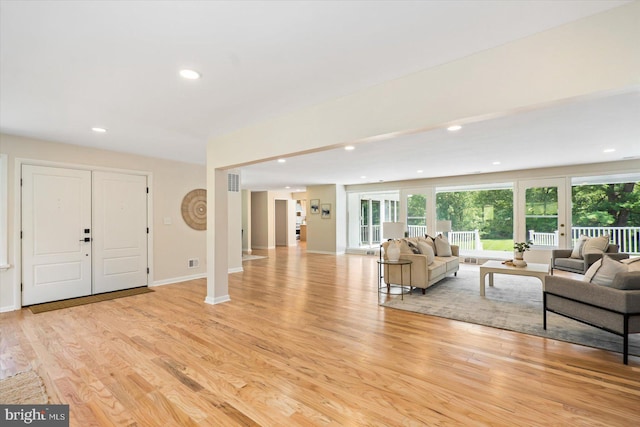 living area featuring recessed lighting, light wood-style flooring, visible vents, and baseboards