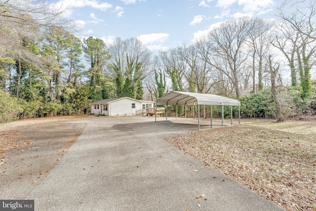 view of front of house featuring a carport and aphalt driveway