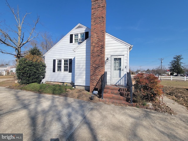 view of front facade featuring a chimney