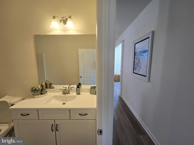 32912 Tern Cv, Long Neck, DE 19966 - half bath featuring toilet, wood finished floors, vanity, and baseboards