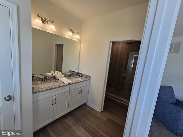 32912 Tern Cv, Long Neck, DE 19966 - bathroom with a shower stall, visible vents, a sink, and wood finished floors
