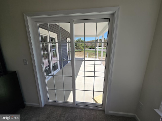 32912 Tern Cv, Long Neck, DE 19966 - doorway to outside with baseboards and carpet flooring