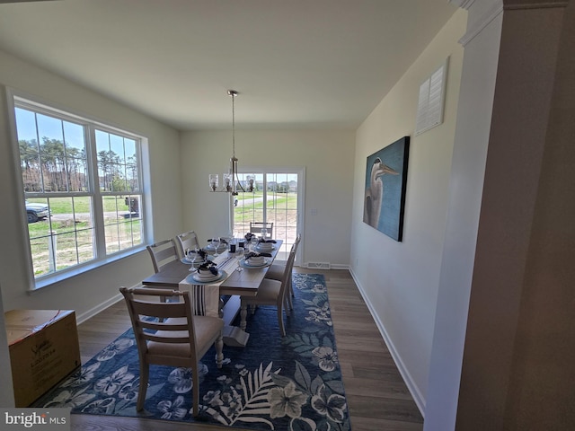 32912 Tern Cv, Long Neck, DE 19966 - dining area featuring a wealth of natural light, dark wood-style floors, baseboards, and an inviting chandelier