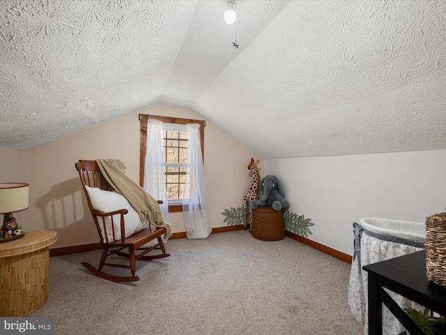 sitting room featuring baseboards, lofted ceiling, a textured ceiling, and carpet floors