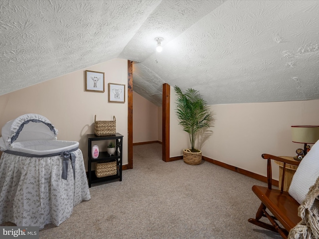 living area featuring baseboards, a textured ceiling, carpet floors, and vaulted ceiling