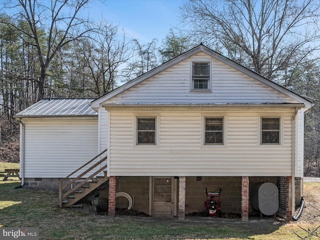 back of property with metal roof and stairway