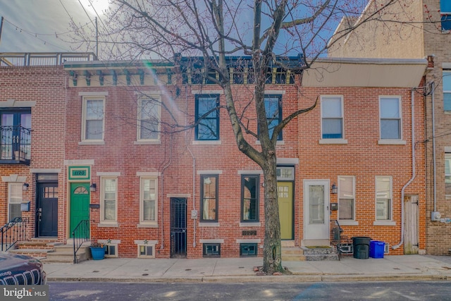 view of front facade featuring brick siding and entry steps