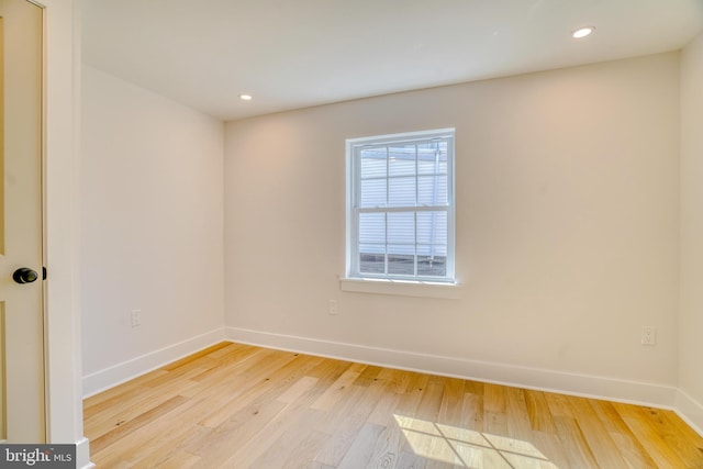 empty room with recessed lighting, baseboards, and light wood finished floors