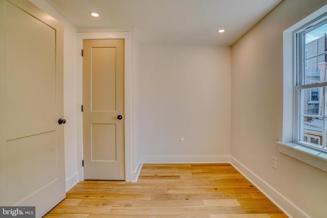 unfurnished room featuring recessed lighting, baseboards, and light wood-type flooring