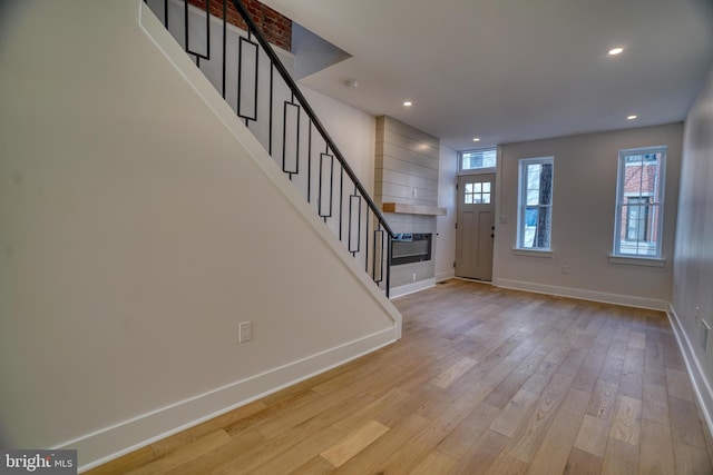 entryway featuring recessed lighting, stairway, baseboards, and light wood-style floors