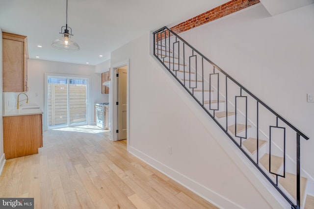 staircase featuring recessed lighting, baseboards, and wood finished floors